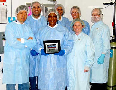The Vegetable Production System team, called VEGGIE for short, at Kennedy Space Center poses outside of the International Space Station Environment Simulator Chamber #3 within the Space Station Processing Facility. The chamber temporarily houses the VEGGIE facility and VEG-01 hardware. The team is conducting the Simulating Another Science verification test of VEGGIE here on Earth before the unit is flight-certified for use on the International Space Station. VEGGIE is scheduled to launch aboard SpaceX’s Dragon capsule on a NASA Commercial Resupply Services mission. Pictured from left to right: Front row: Felix Joe, Charmel Jones, Nicole Dufour; Back row: Bryan Onate, Gioia Massa, Gerard Newsham , and Don Metzger. (NASA image)