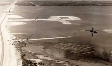 In October 1951, a bulldozer cut through from the harbor to the sea and the waters of the Atlantic Ocean began to merge with those of the Banana River as the tides finished the job. (Port Canaveral image)
