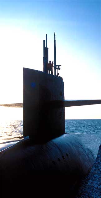 A United States Navy Trident submarine entering the Port. In the late 1970s the U.S. Navy completed the Trident Submarine Basin at the Port and this project also served as an interim substitute for sand bypassing, as more than 2,800,000 cubic yards of sand, dredged to create the basin, was placed on the beach south of the Port. (Port Canaveral image)