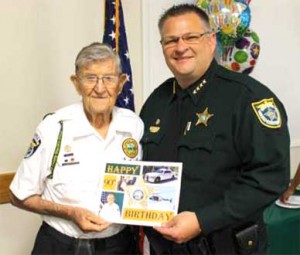 Brevard County Sheriff Wayne Ivey congratulates Citizen Observer Patrol (COP) volunteer Vince Wilson on his 90th Birthday. (Image for SpaceCoastDaily.com)