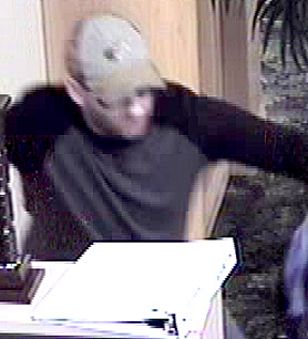 SUSPECT 2: White, male wearing a tannish gray baseball hat with some sort of sport fishing logo on it and the same as Suspect #1’s hat, a baseball style undershirt with long sleeves not ¾ sleeves that were black or dark blue with a gray middle. (TPD image)