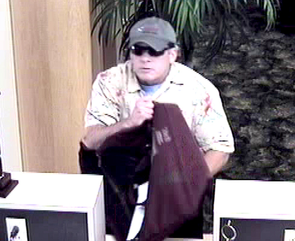 SUSPECT 1: White, male wearing a tannish gray baseball hat with some sort of sport fishing logo on it, a yellow and white Hawaiian print shirt with a blue shirt underneath it and either blue jeans or khaki colored pants. (TPD image)