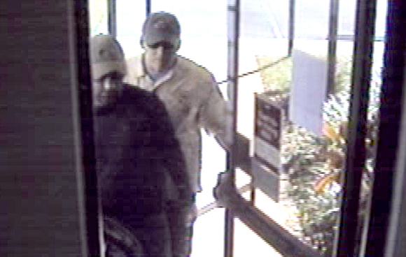 Two males entered the bank and one jumped over the teller desk; while the second stood watch. The customers and staff were ordered to lay on the floor while the robbery took place. No weapons were observed or implied. (TPD image)