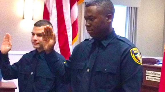 Chief Mike Cantaloupe administered the Oath of Office to two new officers on Monday. Chris Delgado, 22 and Nicholas Hall, 23 accepted the oath before a small crowd of family, friends and police command staff during a brief special ceremony held in the Council Chambers at City Hall. (Image for SpaceCoastDaily.com)