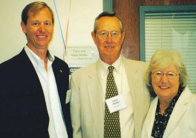 Mark with his dad, Gary, and his mom, Pat, far right. Gary retired 25 years after starting the business. (Image for SpaceCoastDaily.com)