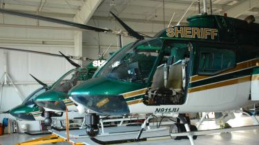 A number of Brevard County Sheriff's Aviation Unit helicopters in the hangar at Merritt Island Airport stand ready for flight to patrol the skies over the Space Coast. (Image by John M. Egan)