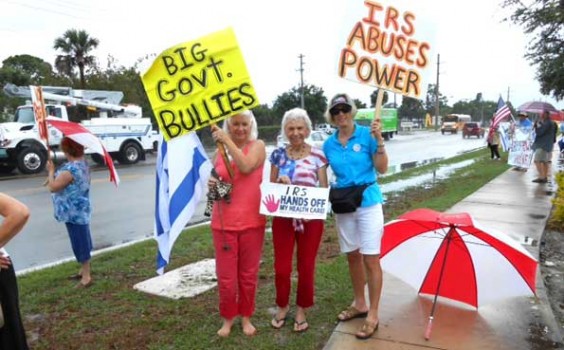 Protesters waved homemade signs with inscriptions including "Big Government out of Control," "Welcome to the U.S.S.A," "IRS is abusive and corrupt," and "IRS shame on you."