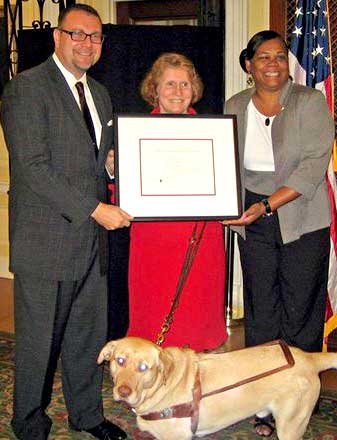 Brevard County Libraries Director Jeff Thompson and Talking Books Department Supervisor Debra Martin pose with Karen A. Keninger (center), director of the Library of Congress National Library Service for the Blind and Physically Handicapped. Brevard County's Talking Books Library received the Network Sub-regional Library of the Year Award last month in Washington, D.C. (Image for SpaceCoastDaily.com)