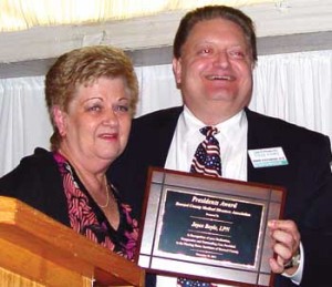 LONG TERM CARE AWARD: Dr. John H. Potomski Jr., DO, CMD, President of BCMDA presents the 2012 Long Term Care Achievement Award to Joyce Boyle. The 2013 Annual Long-Term Care Symposium will take place on Wednesday, Nov. 6 as part of Space Coast Medicine Week, and will be hosted by the Brevard County Medical Directors Association. (Space Coast Medicine & Active Living image) 