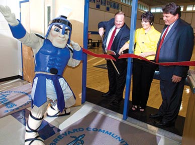 EASTERN FLORIDA STATE COLLEGE President Dr. Jim Richey, Melbourne Campus Provost Sandy Handfield and Athletic Director Jeff Carr cut the ribbon to officially unveil the new gymnasium floor in the Athletic Building at the Melbourne Campus. (EFSC image)