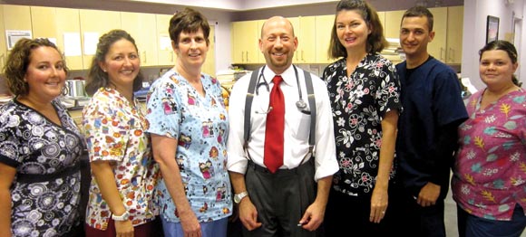 ATTENTIVE STAFF: Left to right – Kelly Hartman,LPN; Lisa Lang, Office Manager; Kathleen DeBickes, Lab Technician; Dr. Mark Pinsky; Michele Bessette, Billing; Alex Fiers, M.A. Student; and Danielle Gluskin, Front Receptionist. (Space Coast Medicine & Active Living) 