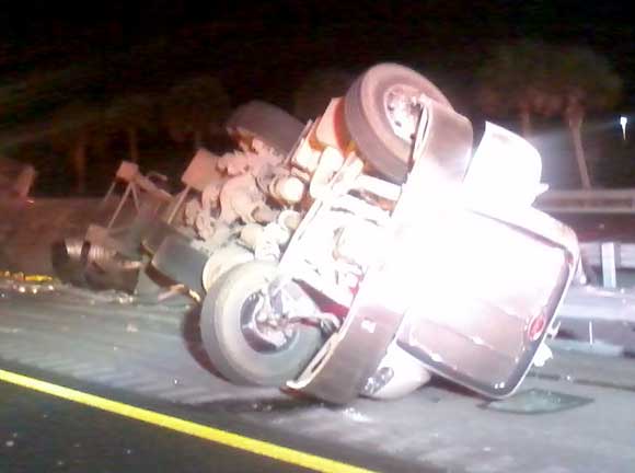 The truck was carrying 45,000 pounds of hot tar. Twenty gallons spilled, but there was no damage to the road. Including the Haz/Mat unit, seven units and two district chiefs responded to the scene. (BCFR image)