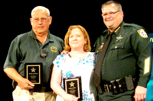 Media Specialist Cheryl Sink, center, and Crew Supervisor Jimmy Fielding, left, receive their awards from Sheriff Wayne Ivey. (SpaceCoastDaily.com image)