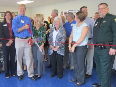 Mark Hobbs cuts the ribbon to unveil Hobb's Pharmacy's new Gary & Pat Hobbs Community Room. (Cyndi Byars image)