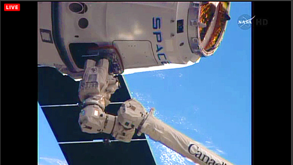 Capture is confirmed! Dragon now attached to station's robotic arm, ready for final berthing and cargo unload. (SpaceX image)