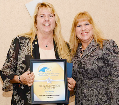 Theresa Clifton, left, Executive Director of the Central Brevard Humane Society receives the Non-Profit of the Year award from Dina A. Reider-Hicks with Waste Management Inc. of Florida. (CBHS Image)