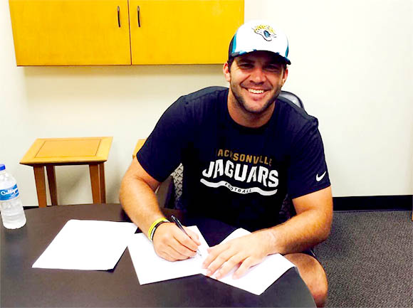 Former UCF quarterback, Blake Bortles, signs his rookie contract with the Jacksonville Jaguars. (Jacksonville Jaguars image)