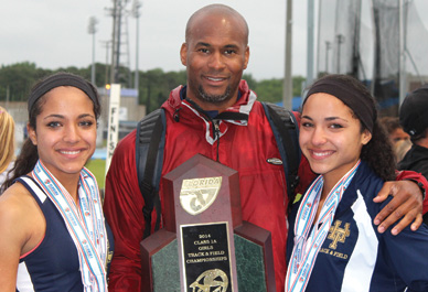 Daryth and Gaby Gayles with their Holy Trinity and summer track sprint coach, Marcus Bailey. “Daryth and Gaby have been a huge part of our track program for almost six years now,” said Holy Trinity track coach Doug Butler. (Image For SpaceCoastDaily.com)