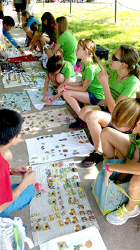 Odyssey of the Mind World Finals team member take away not only an outstanding educational experience, but one of camaraderie and fun. Above, participants wheel and deal with their competitors from around the world as they trade event pins. (SpaceCoastDaily.com image)