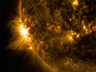 A solar flare bursts off the left limb of the sun in this image captured by NASA's Solar Dynamics Observatory on June 10, 2014, at 7:41 a.m. EDT. This is classified as an X2.2 flare, shown in a blend of two wavelengths of light: 171 and 131 angstroms, colorized in gold and red, respectively. (NASA.gov Image)