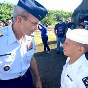 Retired Rear Adm. Wayne Justice talks with an elite U.S. Sea Cadet at the graduation on Saturday. (SpaceCoastDaily.com image)