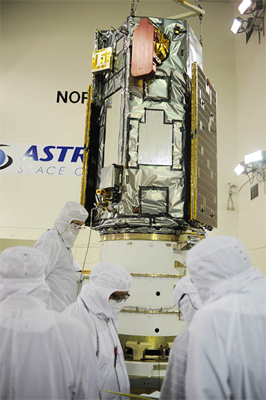 Technicians and engineers work with the OCO-2 spacecraft during processing inside a facility at Vandenberg Air Force Base in California. (NASA.gov image)