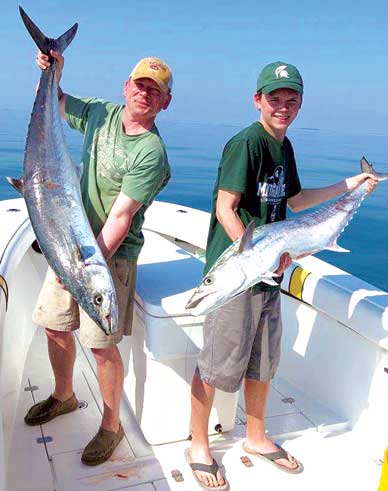 BRIAN BRENDAN, below left, and his son show off their catch of King Mackerel. Kings range drastically in size. On a normal day they can range anywhere from 6 to 45 pounds with an average of 10 to 15 pounds. The regulation size for King Mackerel is 24 inches to the fork. However, most of our population will be well over the minimum. (SpaceCoastDaily.com image)