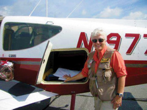 Air traffic controllers at Melbourne International Airport have a good idea when Pat Picornell is coming in for a landing. She is the one with all the barking dogs inside her plane. “When we fly for the Humane Society of Grand Bahamas in Freeport, we wear survival gear to include a life vest...just in case,” Picornell said. (Image for SpaceCoastDaily.com) 