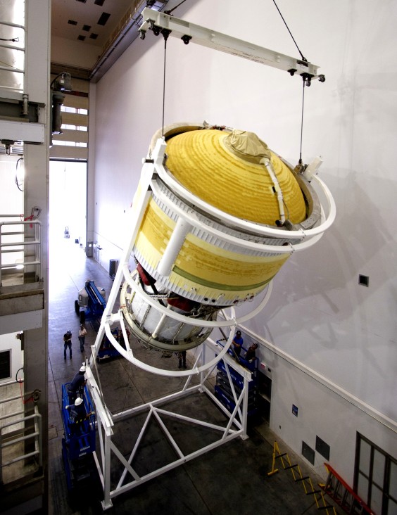 Inside the Delta Operations Center near Space Launch Complex 37 on Cape Canaveral Air Force Station, the second stage for the United Launch Alliance Delta IV Heavy for Exploration Flight Test-1 is lifted high by crane for the move to a test cell. (NASA.gov image)