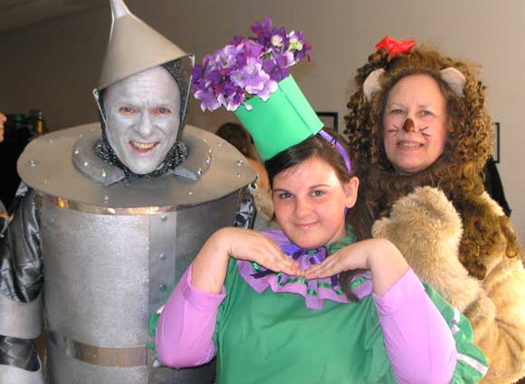 The Hats and High Heels fundraiser for Habitat for Humanity of Brevard County drew on “The Wizard of Oz” for this year’s theme. Left to right, Board Chairman Bill Welser playing the Tin Man; Marilyn Cook, a Habitat volunteer playing the  Cowardly Lion; and Melody Weller as a munchkin. (Nancy Lundell image) 