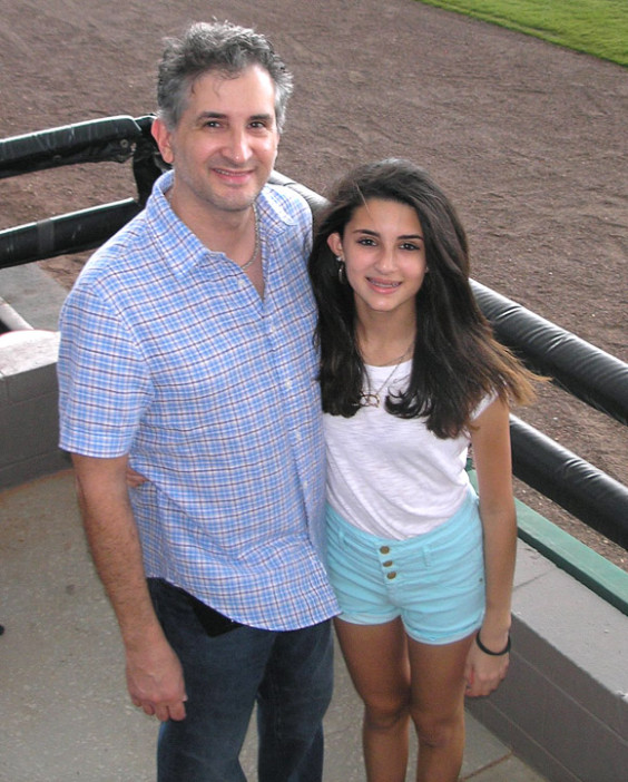 Dr. Todd Panarese with daughter Jenna Panarese, who was standing by to sing the National Anthem to start the game at Strike Out Cancer Night at Space Coast Stadium. (Nancy Lundell image)