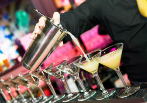 barmans hand with shaker and cocktails