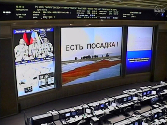 Screens at the Mission Control Center in Russia signify a safe landing for the Expedition 41 trio inside the Soyuz TMA-14M spacecraft. (NASA TV image)