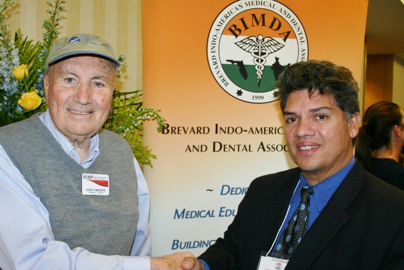 John Trieste, left, greets Carlos Rodriguez at the 2014 BIMDA Conference in Melbourne, Florida.