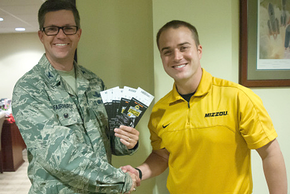 Mizzou Assistant AD Brent Lewis gives tickets to Colonel Shawn Fairhurst of the 45th Space Wing. (MUTigers.com image)