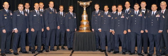 Members of Rooster 73 Flight pose for a group photo after being presented the 2013 Mackay Trophy for the most meritorious flight of the year at the National Aeronautic Association Fall Awards Dinner recently in Arlington, Va. Three 920th Rescue Wing pararescuemen were part of the mission (from left to right, back row, to the left of the trophy), Tech. Sgt. Dan Warren, Staff Sgt. Lee Von Hack-Prestinary and Tech. Sgt. Jason Broline. The crew earned the award for their heroic efforts to safely evacuate American citizens and provide medical care to the passengers who were critically injured when their CV-22 Osprey came under heavy enemy fire during the mission. (Image for SpaceCoastDaily.com)