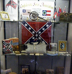 The display included Confederate flags, pieces of Confederate military uniforms, books, photos, and a logo of the organization. (Image for SpaceCoastDaily.com)