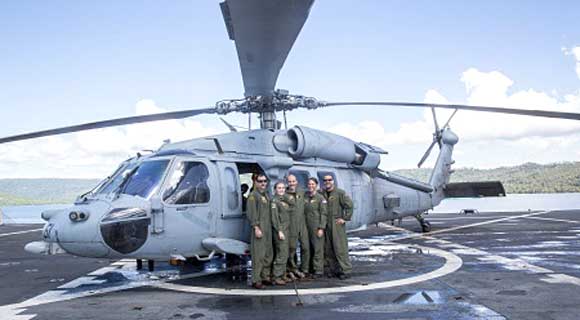 (From left) Lt. Junior Grade Jonathan Yaede, Lt. Julie Froslee, Naval Air Crewman 3rd Class Erik Courtney, Naval Air Crewman 3rd Class Taryn Billings, and Hospital Corpsman 1st Class Matthew Hawkins, with Helicopter Sea Combat Squadron 21, pose in front of an MH-60S Sea Hawk helicopter during Pacific Partnership 2015. 