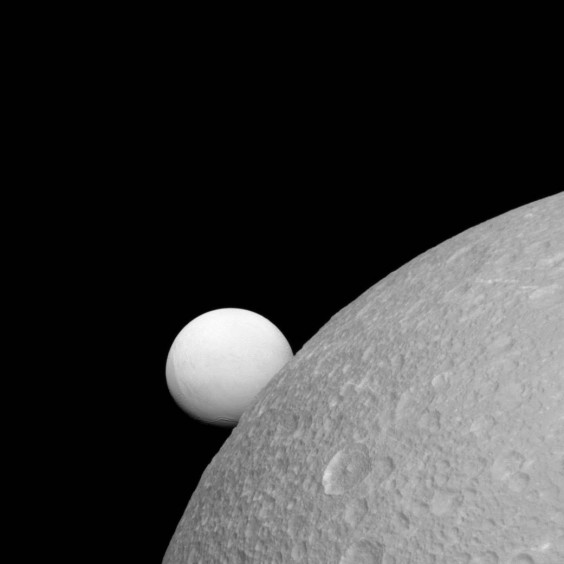 Although Dione (near) and Enceladus (far) are composed of nearly the same materials, Enceladus has a considerably higher reflectivity than Dione. As a result, it appears brighter against the dark night sky. (NASA Image)