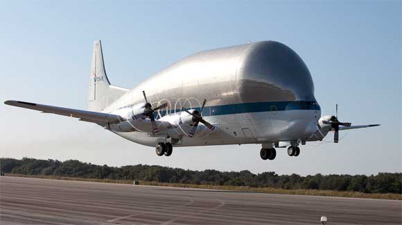 NASA's Super Guppy aircraft, containing the Orion service module stacking assembly interface ring and stack holding stand, takes off from the Shuttle Landing Facility at NASA's Kennedy Space Center in Florida. The interface ring and stand were secured on a special transportation platform inside the aircraft. The Guppy will fly from Kennedy to NASA Glenn Research Center's Plum Brook Station facility in Sandusky, Ohio. Orion is the spacecraft that will launch atop NASA's Space Launch System rocket on Exploration Mission-1 in 2018. Photo credit: NASA/Kim Shiflett