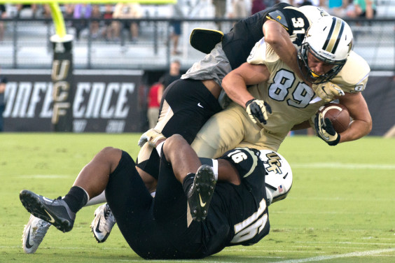 Hayden Jones dragging two defenders at the 2016 UCF Spring Game. (Colin Ziemer, Space Coast Daily Image)