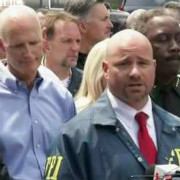 Asst. Spc. Agent in Charge Ron Hopper with Gov. Scott in background June 12 (YouTube Image)