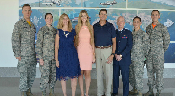 Madison Zook (center), poses with her parents Rhonda and Lee July 29, 2016 after members of the Air Force Technical Applications Center’s Company Grade Officers Council presented the teen with the council’s annual $500 cholarship award in AFTAC’s headquarters located at Patrick AFB, Fla. From left to right: Capt. Stefan Fagan-Kelly, 2nd Lt. Emily Theobald, Rhonda Zook, Madison Zook, Lee Zook, 1st Lt. Michael Duff, 1st Lt. Joshua Hall and 2nd Lt. James Stofel. (U.S. Air Force photo by Susan A. Romano)