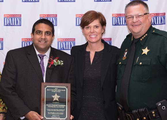 Doctors' Goodwill Foundation President Ashish Udeshi, left, is presented with the "Outstanding Non-Profit" award by Sheriff Wayne Ivey and his wife Susan during the first annual Space Coast Public Service Awards & Hall of Fame Induction Gala at the King Center on September 24. The Space Coast Daily Awards Committee reviewed an incredible list of nominations and recognized more than 100 extraordinary Space Coast Public Servants during this very special event. (Steve Wilson image)