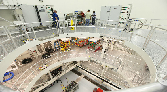 On the top level of the service platform, engineers and technicians check out some of the ground support equipment that will be used to service Orion spacecraft inside the Multi-Payload Processing Facility.