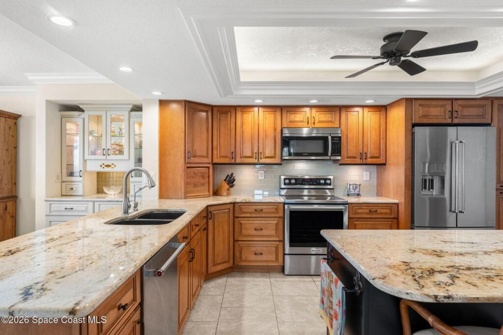 Updated kitchen with granite counters and movable granite island at 1835 S Atlantic Ave #301, Cocoa Beach condo listed by Bobby Freeman